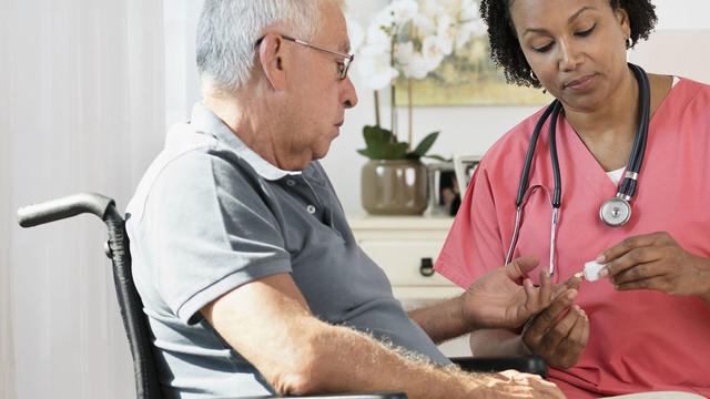 Nurse checking blood glucose 